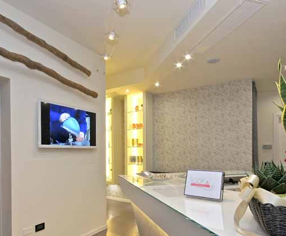 La sala d'attesa con poltrone allineate e schermo a parete